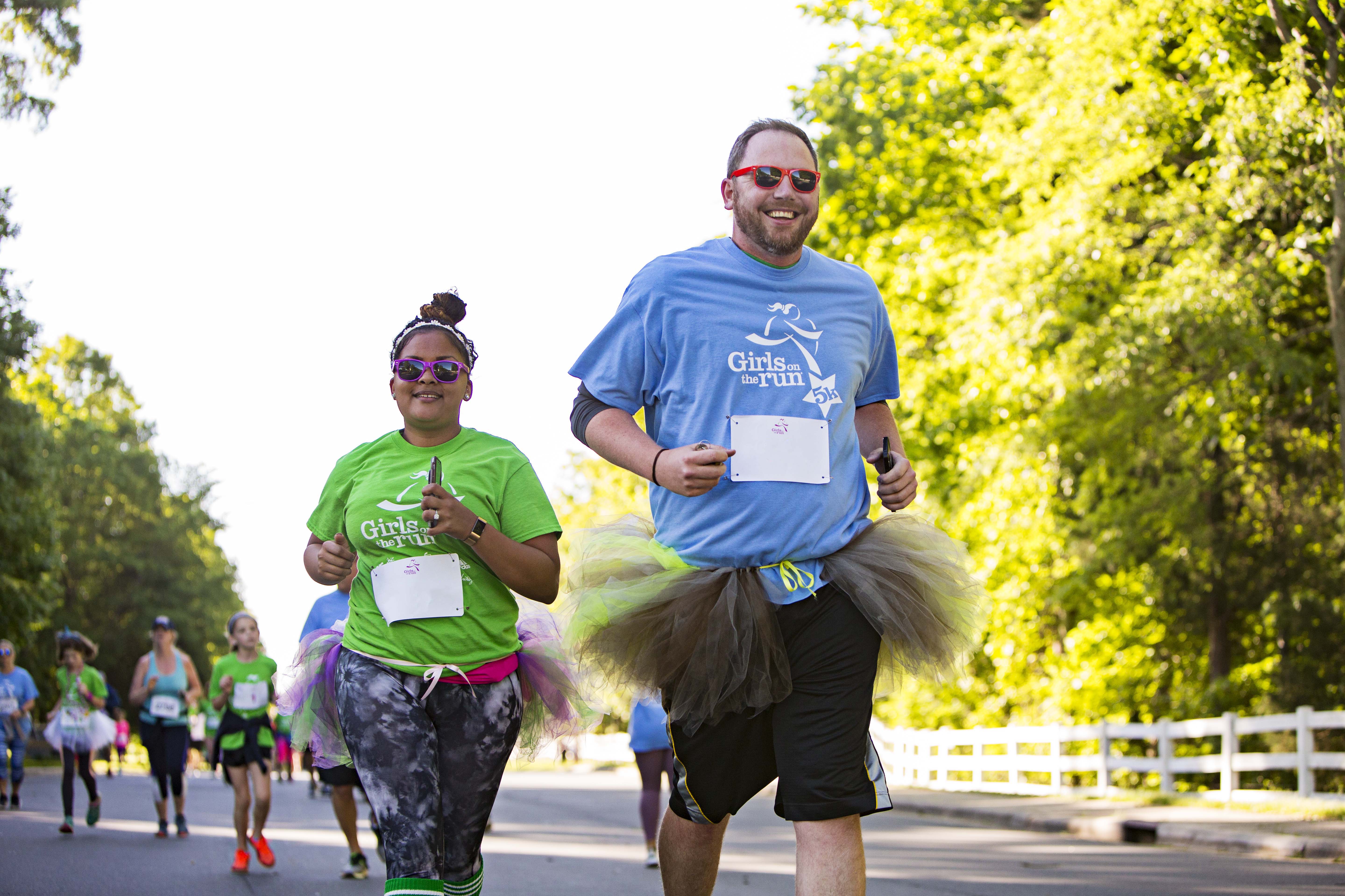 Two Girls on the Run Coaches smile while running 