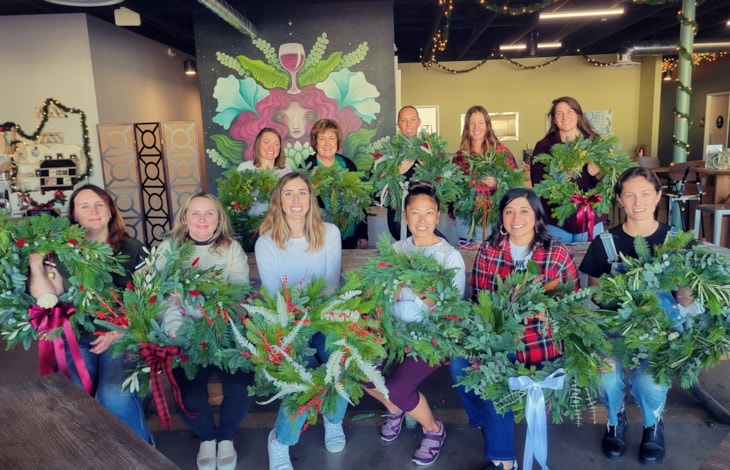 Wreath making workshop participants and their wreaths